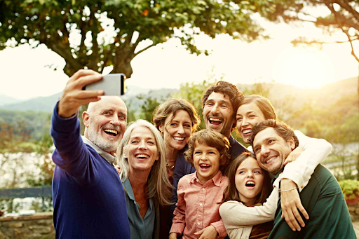 A family smiling and taking a selfie.