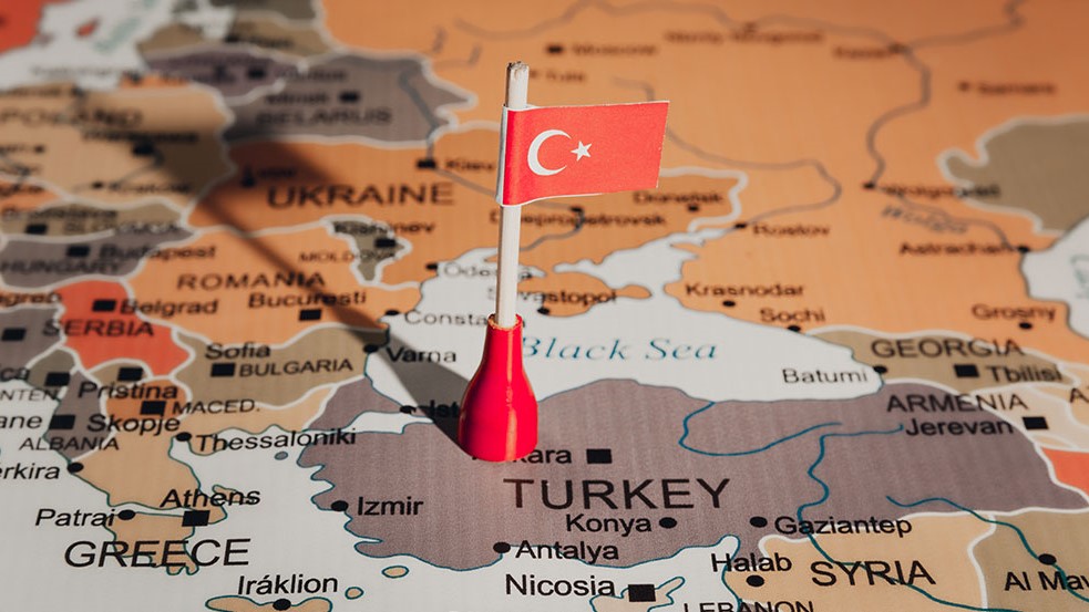 Turkey flag pin marking Turkey on a map.